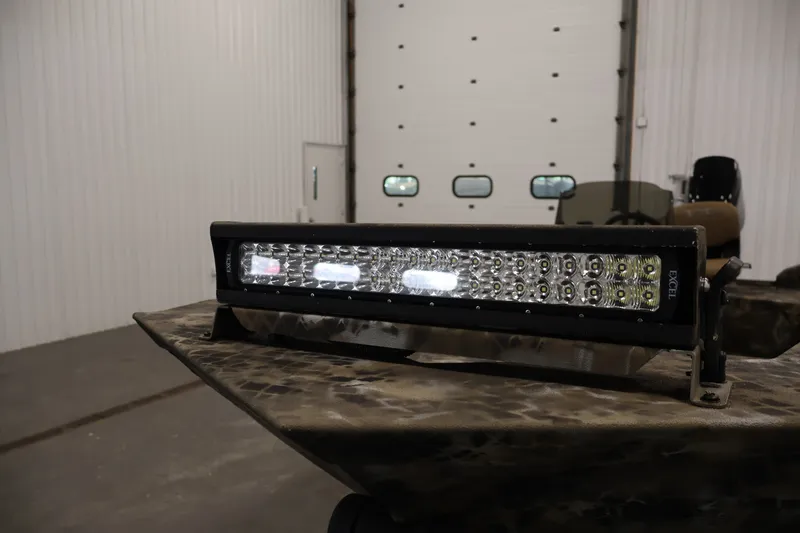 Slide: The Image of 2025 Excel 1651 River Warrior SC boat with LED light bar in a garage setting. - 11