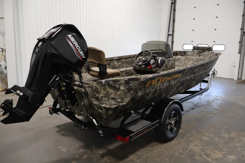 Slide: The Image of 2025 Excel 1651 River Warrior SC boat with Mercury engine in a garage setting. - 5