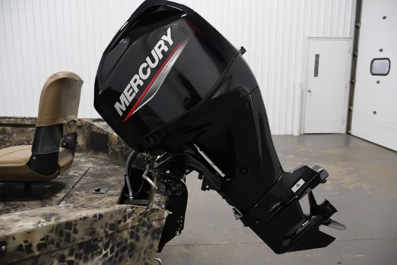 Slide: The Image of 2025 Excel 1651 River Warrior SC with Mercury outboard motor in a garage setting. - 24