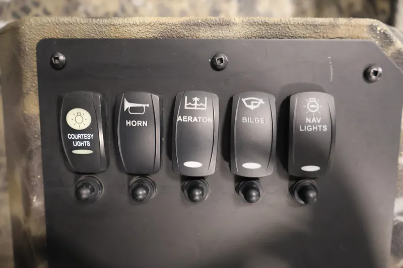 Slide: The Image of Control panel of 2025 Excel 1651 River Warrior SC with switches for lights, horn, aerator, bilge. - 17