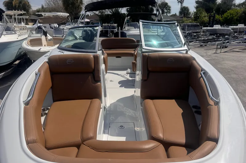 Slide: The Image of 2023 Crownline 250 XSS boat with brown leather seating and open deck layout. - 7