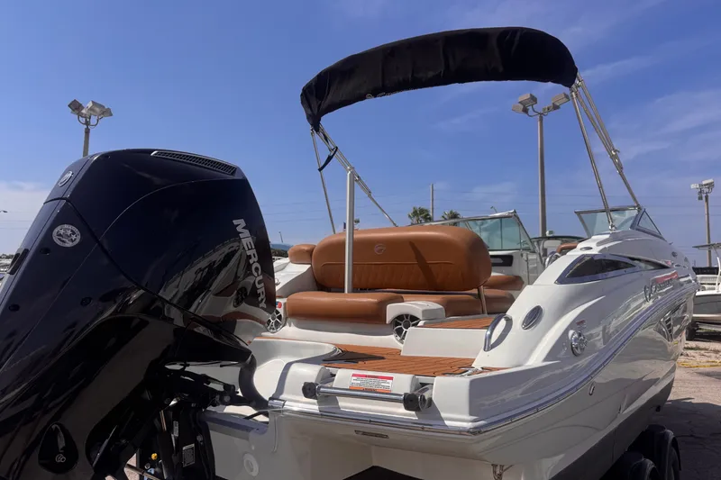 Slide: The Image of 2023 Crownline 250 XSS boat with Mercury engine, featuring sleek design and comfortable seating. - 13