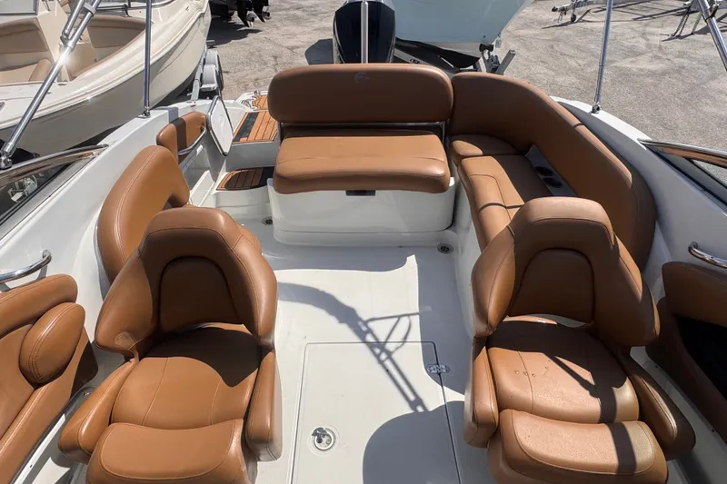 Slide: The Image of 2023 Crownline 250 XSS boat interior with tan leather seating and spacious layout. - 4