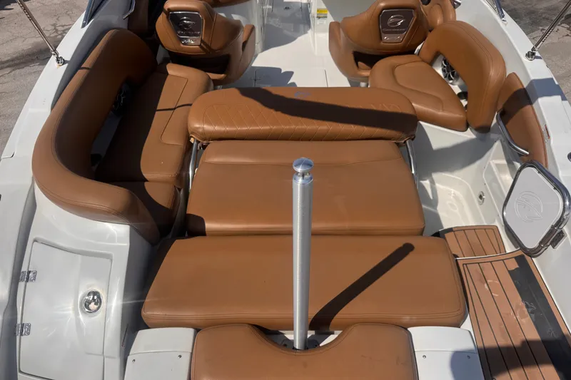Slide: The Image of 2023 Crownline 250 XSS boat interior with tan leather seating and sleek design. - 11