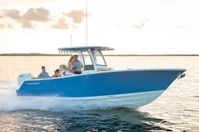 The Image of 2027 Sportsman Heritage 261 Center Console boat cruising on open water at sunset. - 1