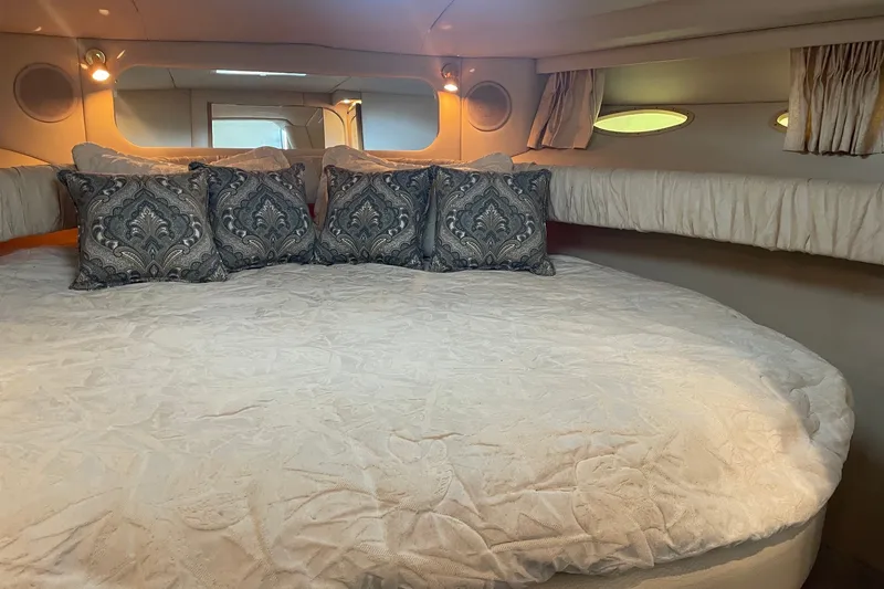 Slide: The Image of Luxurious cabin interior of 1999 Sea Ray 370 Express Cruiser with elegant bedding and pillows. - 22