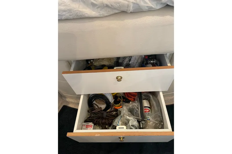 Slide: The Image of Storage drawers on a 1999 Sea Ray 370 Express Cruiser, containing various tools and supplies. - 19