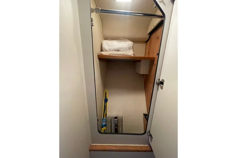 Slide: The Image of Interior storage space of 1999 Sea Ray 370 Express Cruiser with shelves and equipment. - 23