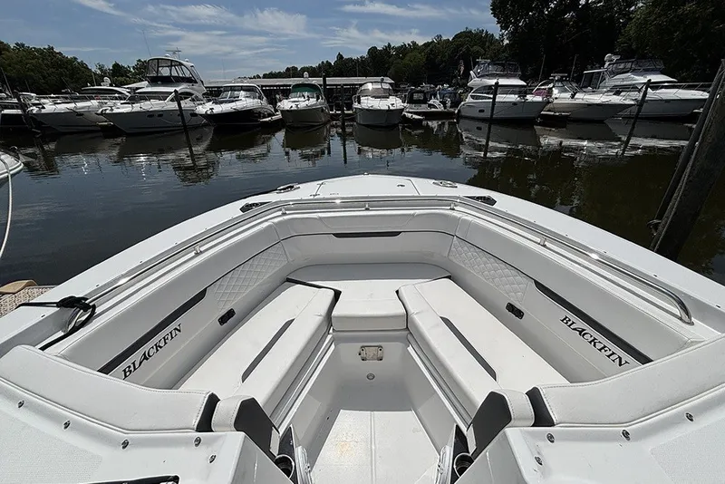Slide: The Image of 2023 Blackfin 272 DC boat interior at marina, surrounded by other boats. - 25