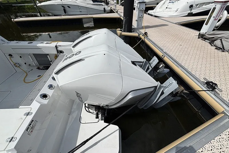 Slide: The Image of 2023 Blackfin 272 DC boat with dual Mercury outboard engines docked at marina. - 5