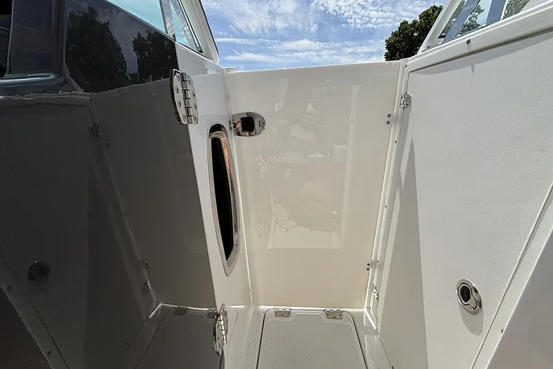Slide: The Image of 2023 Blackfin 272 DC boat interior with open door and sleek design. - 24
