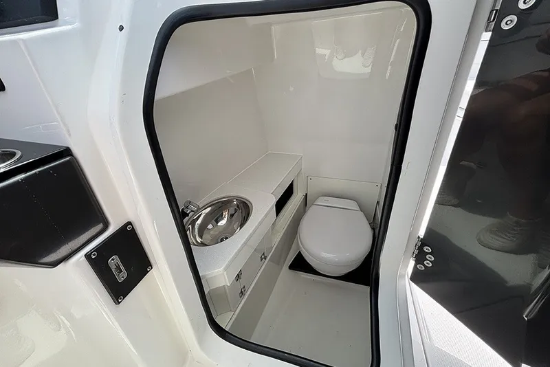 Slide: The Image of Interior view of 2023 Blackfin 272 DC boat bathroom with sink and toilet. - 20