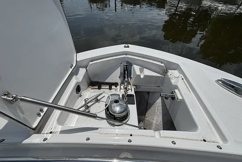 Slide: The Image of Anchor compartment of 2023 Blackfin 272 DC boat, open hatch, docked on water. - 29