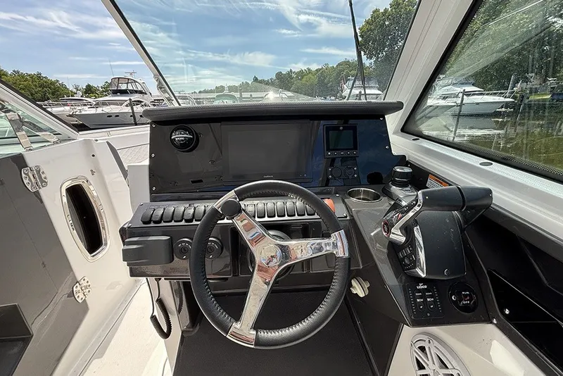 Slide: The Image of 2023 Blackfin 272 DC boat cockpit with steering wheel and control panel. - 16