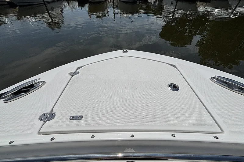 Slide: The Image of Bow of 2023 Blackfin 272 DC boat docked on calm water. - 28