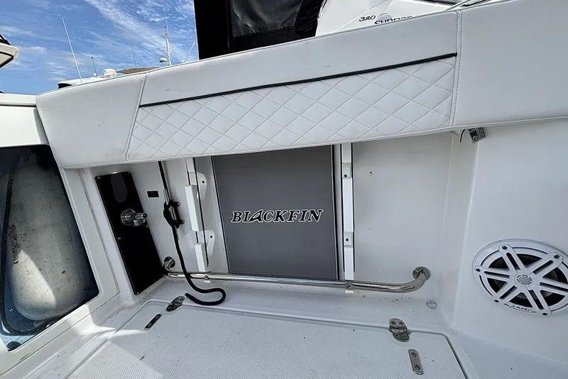 Slide: The Image of 2023 Blackfin 272 DC boat interior with branded panel and speaker. - 9