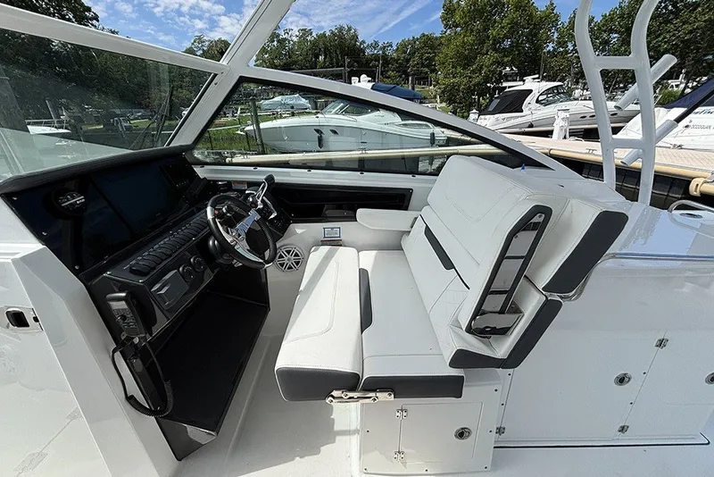 Slide: The Image of 2023 Blackfin 272 DC boat interior with modern helm and seating. - 15