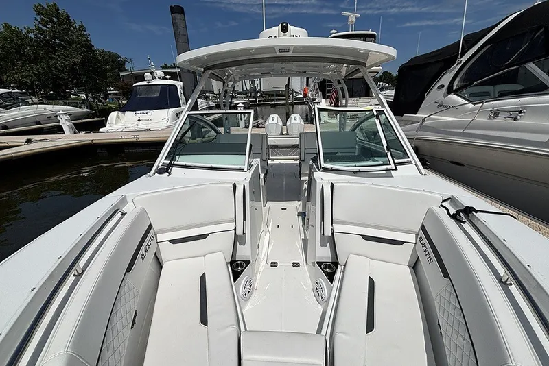 Slide: The Image of 2023 Blackfin 272 DC boat docked, showcasing spacious seating and sleek design. - 30