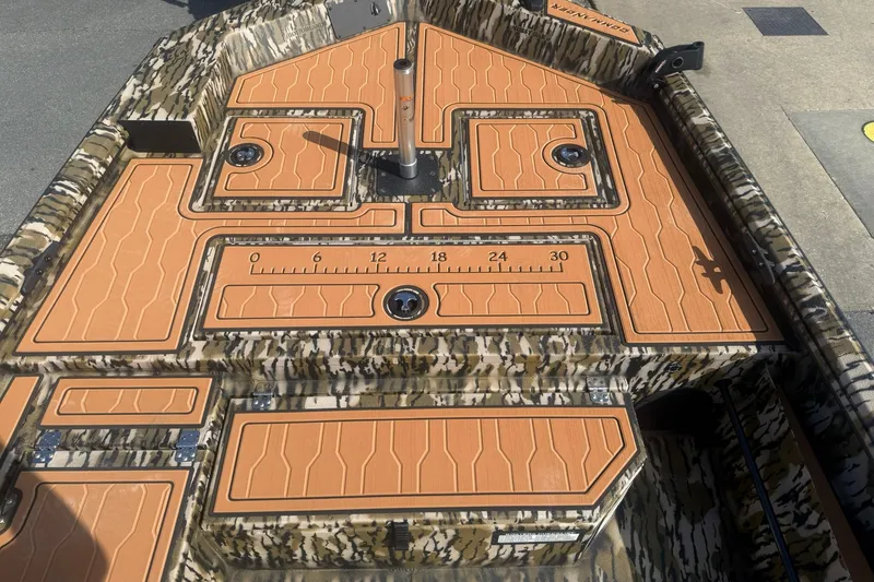 Slide: The Image of 2027 Avid 18 Commander boat deck with camo pattern and orange non-slip surface. - 14