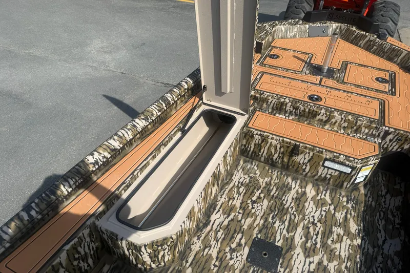 Slide: The Image of 2027 Avid 18 Commander boat interior with camouflage design and storage compartments. - 16