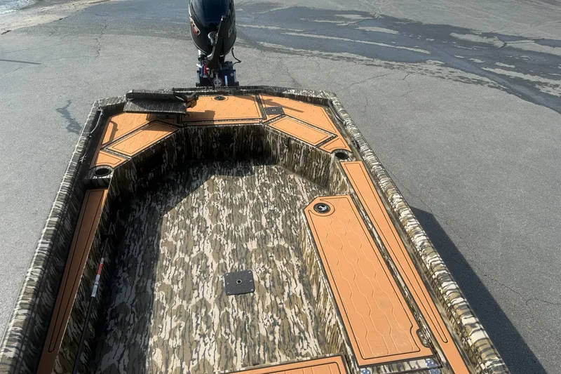 Slide: The Image of 2027 Avid 18 Commander boat with camouflage interior and outboard motor. - 17
