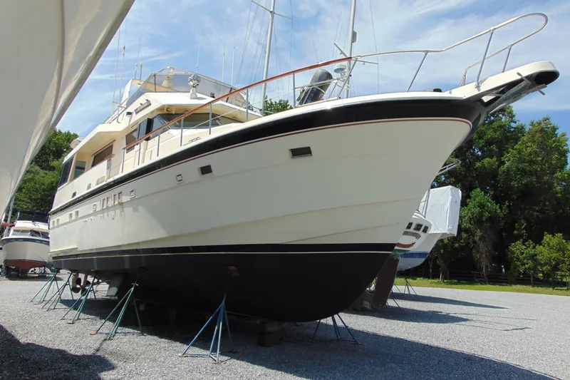 The Image of 1987 Hatteras 54 Motor Yacht on stands, displayed outdoors under a clear sky. - 0