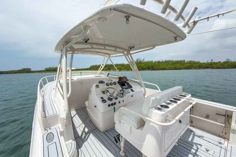 Slide: The Image of 2006 Intrepid 348 Walkaround boat interior with helm, seating, and ocean view. - 32