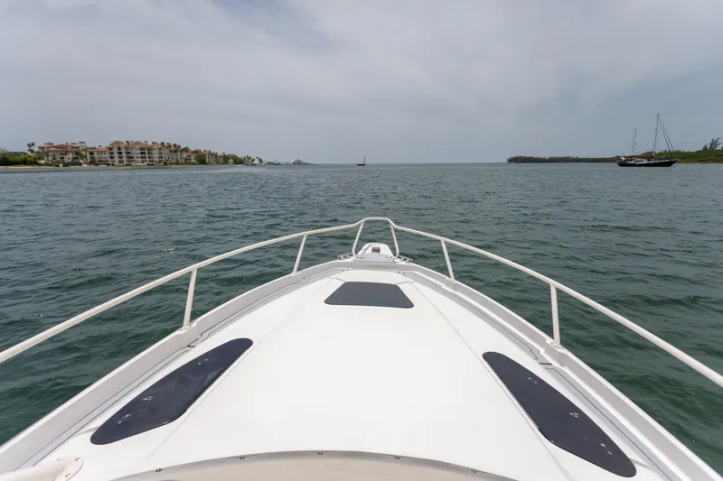Slide: The Image of Bow view of 2006 Intrepid 348 Walkaround cruising on calm waters. - 18