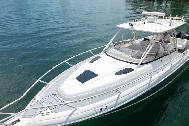 Slide: The Image of 2006 Intrepid 348 Walkaround boat cruising on clear blue water. - 15