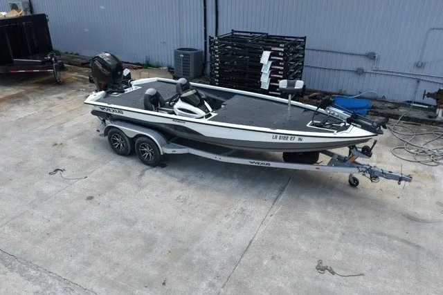 Slide: The Image of 2023 Vexus AVX1980 boat on trailer, parked in an industrial area. - 6