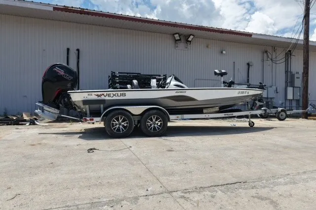 The Image of 2023 Vexus AVX1980 boat on trailer, parked outdoors near a warehouse. - 1