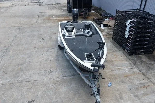 Slide: The Image of 2023 Vexus AVX1980 boat on trailer, parked on concrete surface near industrial area. - 5