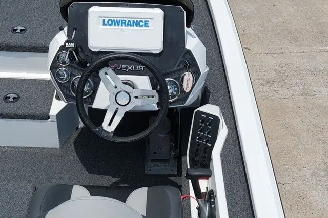 Slide: The Image of 2023 Vexus AVX1980 boat dashboard with Lowrance electronics and steering wheel. - 2