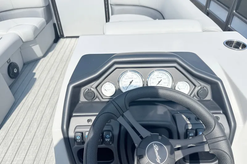 Slide: The Image of 2027 Bentley Pontoons Legacy 200 Navigator dashboard with steering wheel and gauges. - 13