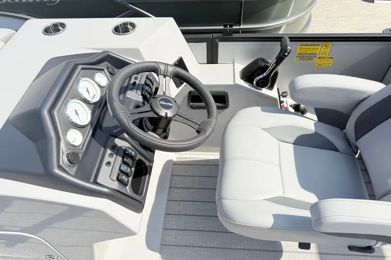 Slide: The Image of 2027 Bentley Pontoons Legacy 200 Navigator helm with steering wheel and gauges. - 9