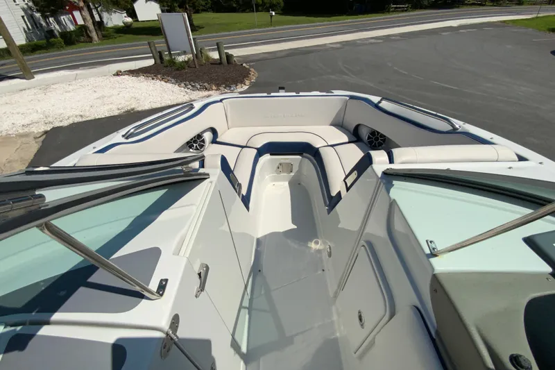 Slide: The Image of 2019 Crownline Eclipse E235 XS boat interior with white seating and blue accents. - 16