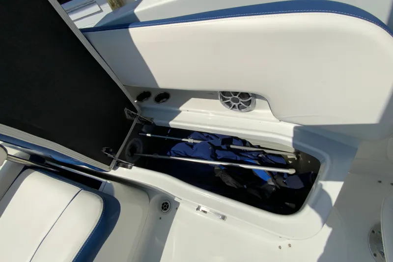 Slide: The Image of 2019 Crownline Eclipse E235 XS boat storage compartment with open lid and visible interior. - 24