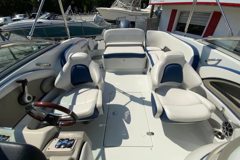 Slide: The Image of 2019 Crownline Eclipse E235 XS boat interior with white and blue seating. - 20