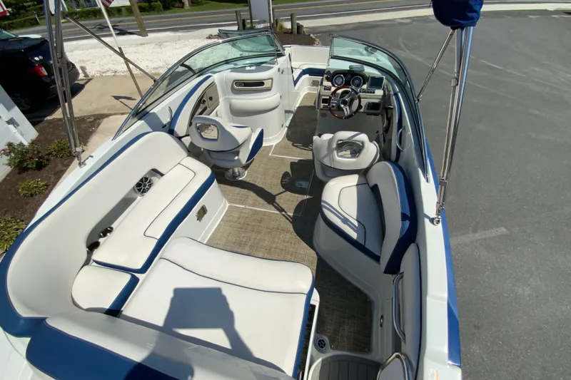 Slide: The Image of 2019 Crownline Eclipse E235 XS boat interior with white seating and modern dashboard. - 27