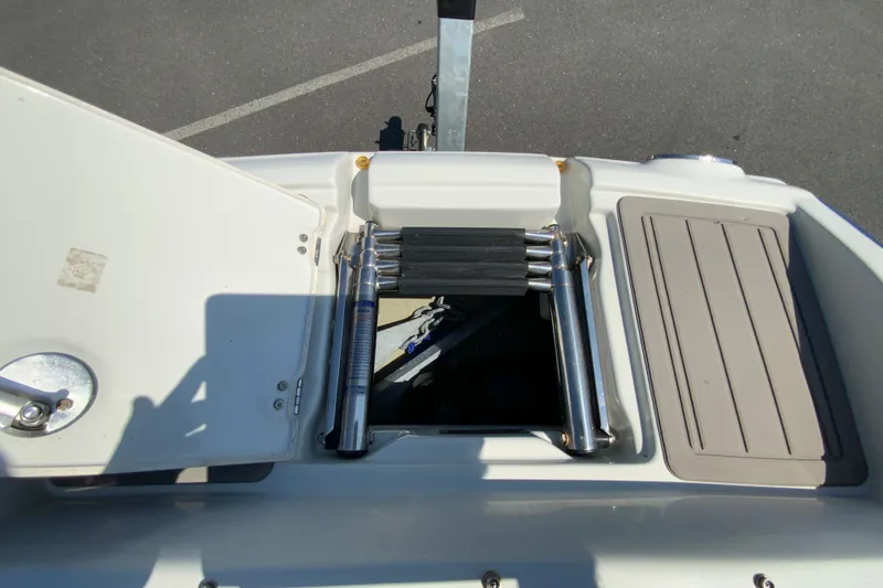 Slide: The Image of 2019 Crownline Eclipse E235 XS boat ladder and storage compartment. - 18