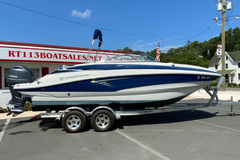 The Image of 2019 Crownline Eclipse E235 XS boat on trailer at dealership, featuring Yamaha outboard motor. - 1