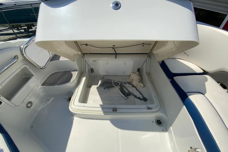 Slide: The Image of 2019 Crownline Eclipse E235 XS boat storage compartment with rope and chain. - 23