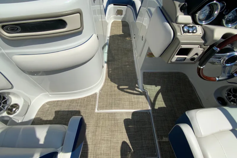 Slide: The Image of 2019 Crownline Eclipse E235 XS boat interior with beige carpet and white seating. - 28