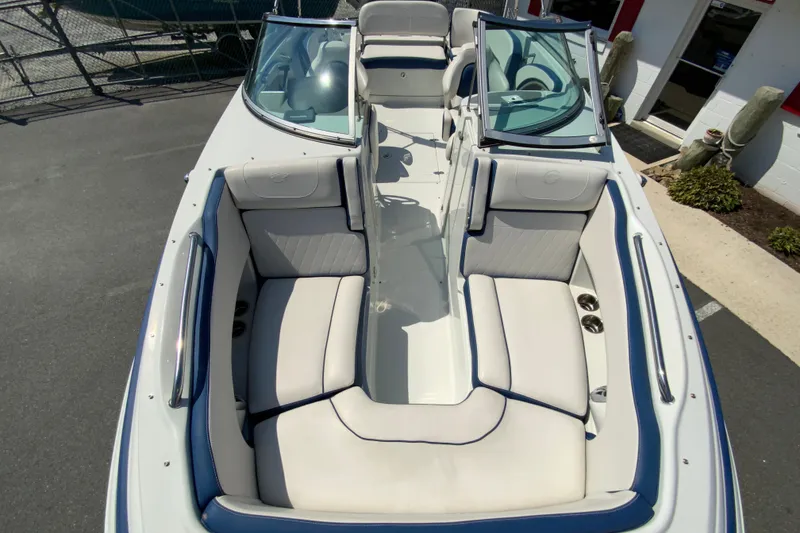 Slide: The Image of 2019 Crownline Eclipse E235 XS boat interior with white seating and blue accents. - 19
