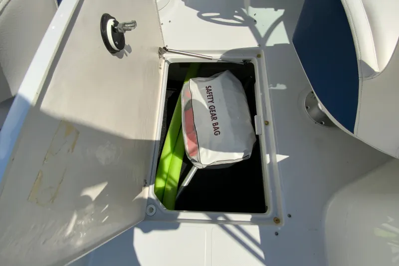 Slide: The Image of 2019 Crownline Eclipse E235 XS boat storage with safety gear bag inside compartment. - 25