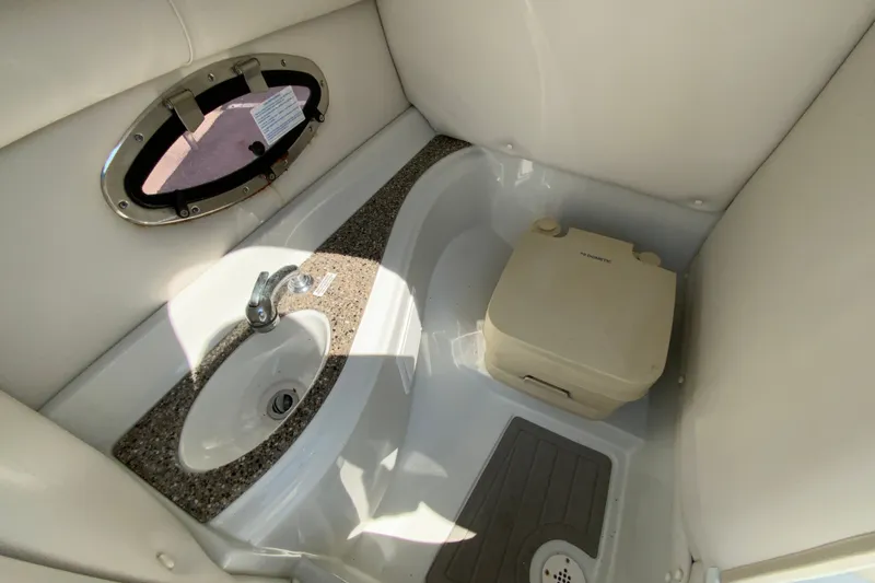 Slide: The Image of 2019 Crownline Eclipse E235 XS boat interior with sink and portable toilet. - 22