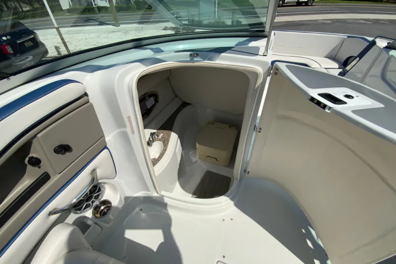 Slide: The Image of 2019 Crownline Eclipse E235 XS boat interior with open compartment and seating area. - 21