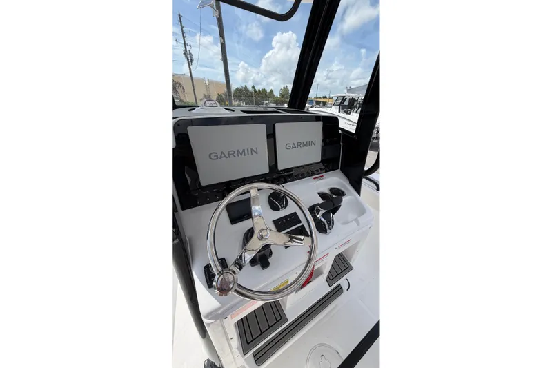 Slide: The Image of 2027 Sea Hunt Gamefish 25 helm with Garmin displays and steering wheel. - 15