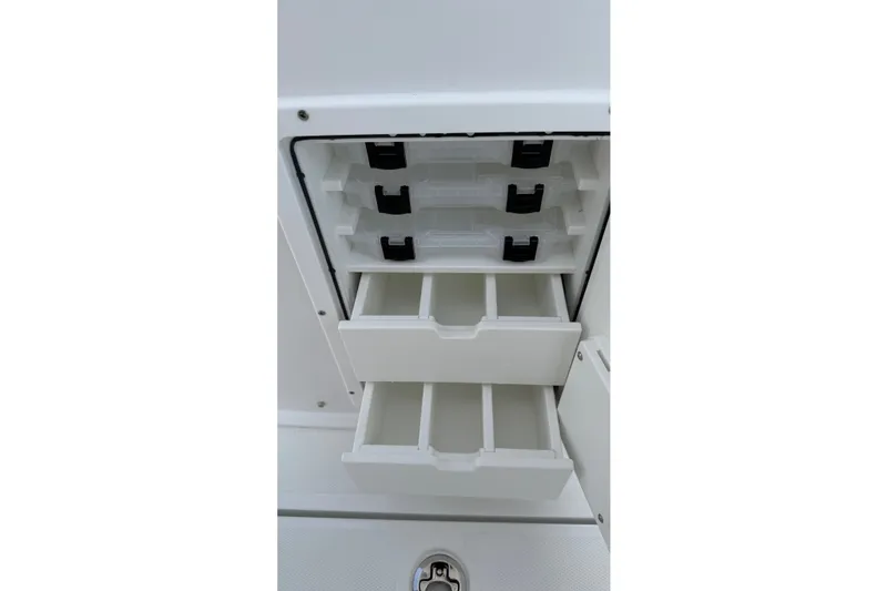 Slide: The Image of Storage compartments on a 2027 Sea Hunt Gamefish 25 boat, featuring organized tackle drawers. - 19