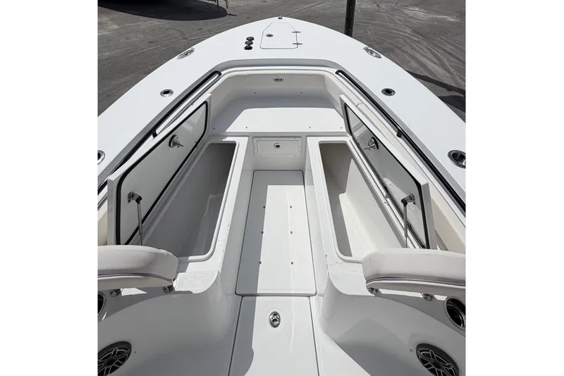 Slide: The Image of 2027 Sea Hunt Gamefish 25 boat interior with open storage compartments, docked outdoors. - 20